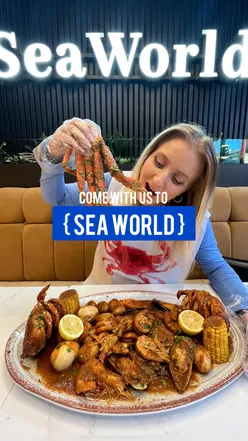 Delicious seafood feast at Seaworld Restaurant, Manchester, featuring prawns, crab, and mocktails in a vibrant setting.