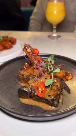 Diners enjoying Togarashi Lamb Chops, Sweet Chilli Wings, and Bread Pudding at Pan Ajia in Oldham.