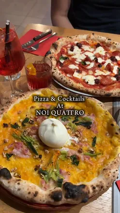 Delicious Neapolitan pizza and cocktails at Noi Quattro in Manchester, perfect for a fun dining experience.