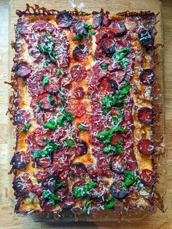 Delicious Detroit Style Chorizo Pizza in a 10x14 pan, showcasing perfect crust and toppings, freshly baked and ready to enjoy.