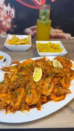 Delicious seafood dishes at Prawn Theory in Leicester, featuring prawns, scallops, and a seafood boil with big portions.