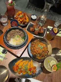 Cozy dining at Kimchee in King's Cross: enjoying flavorful Korean dishes and sharing plates like bibimbap and fried chicken.
