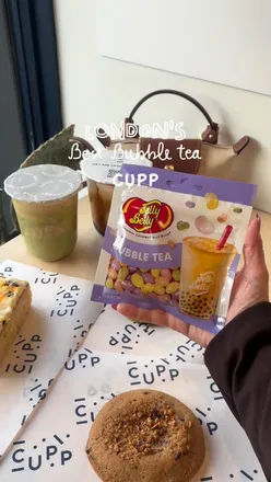 Enjoying Brown Sugar Premium and Pistachio Mocha Boba at CUPP in Gants Hill, East London, with delicious cakes.