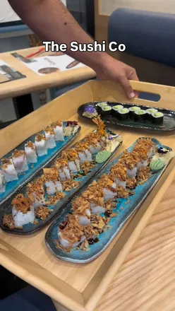 Fresh sushi rolls at Sushi Co, highlighting crispy prawn crunch and avocado maki in a modern dining atmosphere.