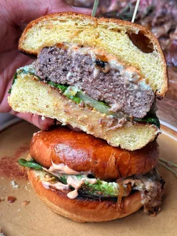 Delicious gourmet burger at Bricco e Bacco, featuring a prime cut patty and buttery brioche bun in London.