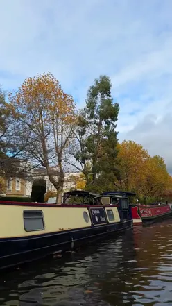 Friends enjoying a GoBoat ride through London's canals during autumn, exploring Paddington Basin and Little Venice.