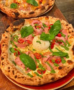 Delicious wood-fired pizzas and appetizers at The Oven Pizzeria in Bath, perfect for pre-theatre dining.