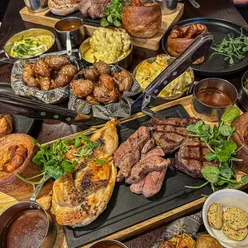 Festive sharing board at Miller & Carter Rothley featuring roast meats, Yorkshire puddings, and delicious sides.