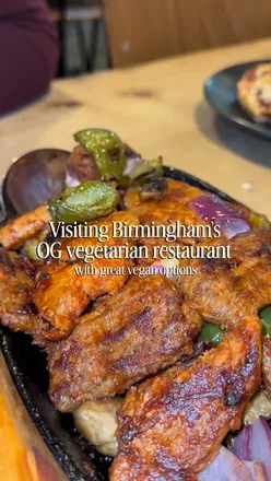 Delicious vegetarian dishes at Mrs Singh's in Birmingham, featuring plant-based pizzas, burgers, and sizzlers.