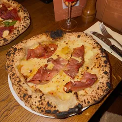 Alpine-inspired pizza with cream, cheese, and smoked chilli jelly at Crust Bros supporting StreetSmart UK in London.