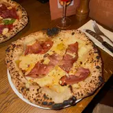 Alpine-inspired pizza with cream, cheese, and smoked chilli jelly at Crust Bros supporting StreetSmart UK in London.