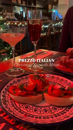 Couple enjoying festive dinner at Prezzo in Edinburgh after ice skating, featuring Christmas carbonara and pigs in blankets.
