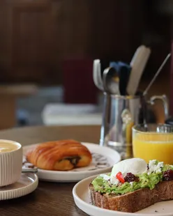 Guests enjoying a lavish hotel breakfast at Wilde Aparthotels in Cambridge, indulging in gourmet dishes and relaxation.