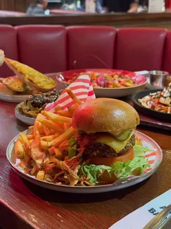 Festive dinner featuring fajitas, pigs in blankets, and cocktails at TGIF Wales, celebrating Christmas with friends.