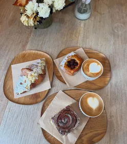 Cozy coffee shop scene with stunning aesthetics, fresh pastries, and steaming cups of coffee in winter.