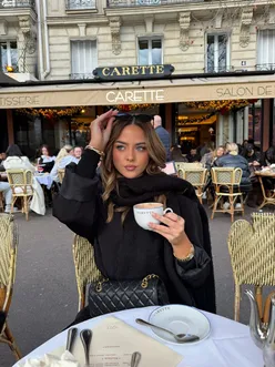 'Enjoying a cozy hot chocolate break at a charming café, surrounded by warm decor and inviting atmosphere.'