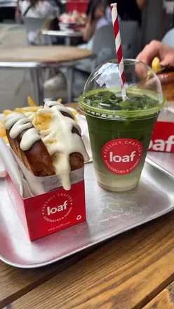 Enjoying a delicious brioche lunch deal at Loaf UK in London with French butter steak sandwich.