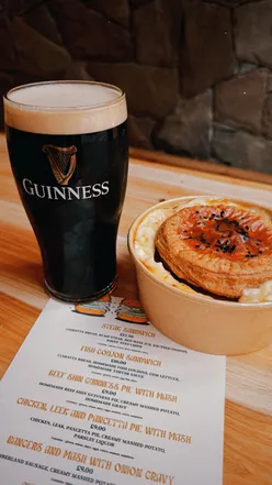 Group enjoying pints and pies at The Prince Newcastle, a trendy spot with Sunday-Thursday cocktail deals.