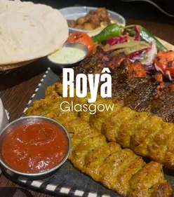 Middle Eastern dishes at Royâ featuring potatoes, Turkish cigars, and fresh hummus in a vibrant dining atmosphere.