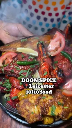 Delicious surf & turf, butter chicken, and naan enjoyed at Doon Spice in Leicester, perfect for family outings.