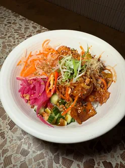 Korean fried chicken donburi with spicy sauce, pickles, and veggies at Koi Fusion in Manchester's New Century Kitchen.