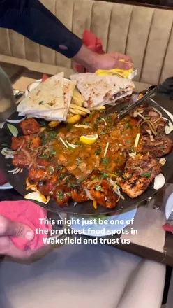 Delicious tawa dish served at Hayat Sweets in Wakefield, showcasing vibrant flavors and inviting presentation.