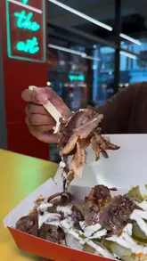 Robots preparing 100% chicken and beef doner wraps at Great British Doner, Manchester, featuring a unique chocolate crepe dessert.