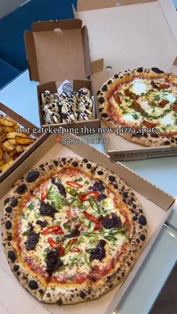 Diners enjoying Korean Beef Pizza and Royale Pizza at the family-run Real Pizza Company in Sutton Coldfield.