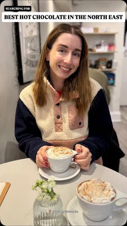 Hot chocolate with whipped cream at Lagom Coffee Bar, a cozy gem in Newcastle with a Scandi vibe.