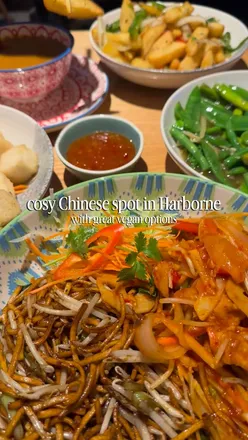 Delicious vegan dishes at Wok Chi in Harborne, featuring salt and pepper tofu, chow mein, and vibrant mixed greens.