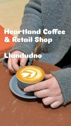 Interior of Heartland Coffee & Retail Shop in Llandudno, showcasing modern design and coffee equipment.