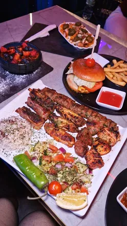 Series of vibrant dishes and shisha at Lahuqqah Lounge, a hidden gem in Leicester with lively atmosphere and great service.