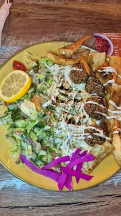 Delicious Egyptian takeaway featuring a Munch Box, kushari, and falafel salad at Giza Nottingham restaurant.