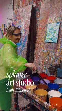Person enjoying a splatter art session in Leith, Edinburgh, creating a mess and expressing creativity.