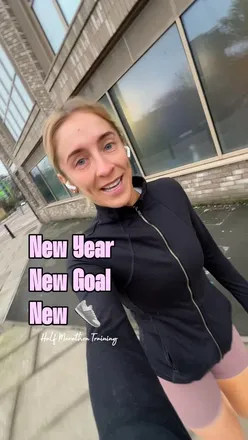 Excited runner showcasing new ASICS trainers while preparing for the Mainz Half Marathon in Germany.