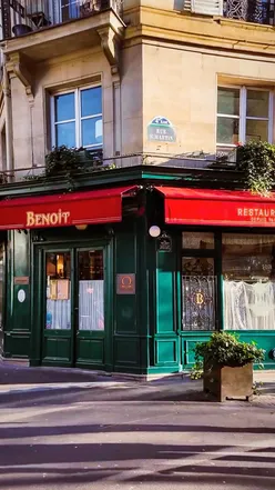 Elegant Parisian dining at Benoît, featuring traditional dishes by Alain Ducasse in a stunning Belle Époque setting.