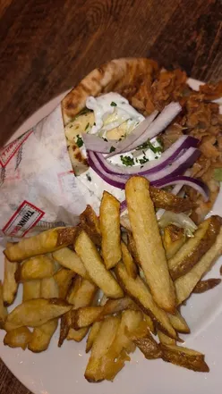 Friends enjoying delicious meals at Kafeneon in Newcastle during Restaurant Week, featuring feta parcels and gyros.