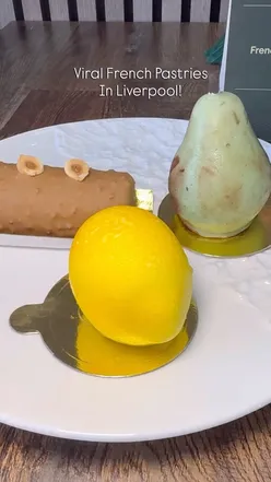 Deliciously crafted desserts at Maison Princess in Liverpool, featuring vibrant fruit-inspired cakes and fine coffee.