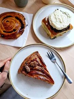 Delicious galettes from top London bakeries; showcasing almond, earl grey, and unique flavors in flaky pastries.