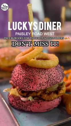 A diner scene at Lucky's Diner, showcasing delicious burgers and wings in a spacious, vibrant setting on Paisley Road West.