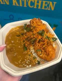 Delicious lunch dishes at Cardiff Market, showcasing beef curry, gyros, pasta, and more from local vendors.