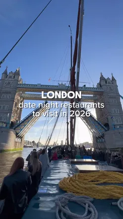 Couple enjoying a romantic dinner at a trendy London restaurant, featuring stylish decor and delicious food.