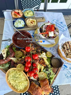 Delicious Mezze platter featuring souvlaki, Greek salad, and halloumi at Ela by Hellas Taverna in Wilmslow, Cheshire.