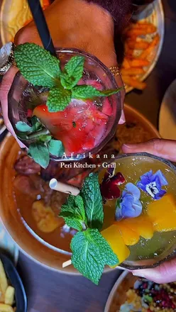 Diners enjoying diverse African-inspired dishes at Afrikana Manchester, featuring vibrant flavors and creative presentations.