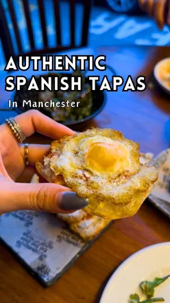 Authentic tapas bar interior with traditional tiles and a cozy atmosphere, featuring gourmet dishes and vibrant Spanish cuisine.