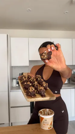 Healthy fitness snack made with dates, dark chocolate, and peanut butter, featuring stylish chocolate gym wear.