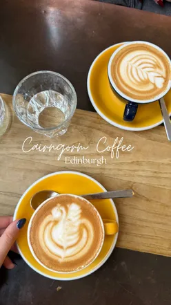 Coffee lovers enjoying brews at Cairngorm Coffee Co. on Melville St, Edinburgh, featuring fun packaging and quality beans.