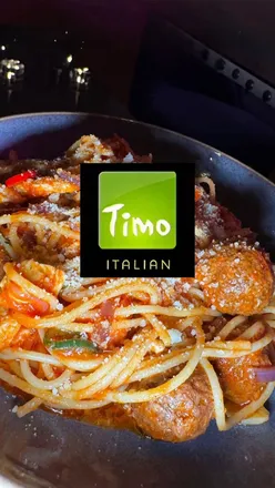 Couple enjoying Italian cuisine at Timo Restaurant in Leicester, featuring starters and desserts in a cozy setting.