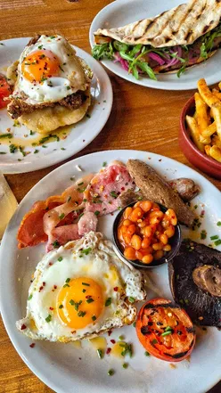 Delicious Turtle Bay breakfast featuring breakfast roti with sausage and Honey Bunny Yardbird in Bristol.