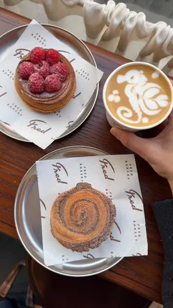 Pastries and latte art at @fredbakery's new Oxford Circus location in January, showcasing a vibrant bakery experience.
